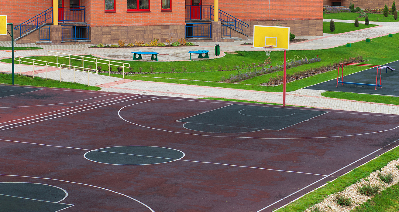 An empty basketball court on a schoolyard